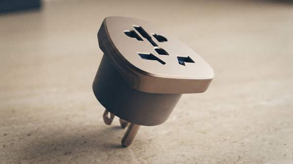 Editorial illustration for Do You Need a Universal Adapter, a Plug Set, or a Voltage Converter? Three Checks Decide