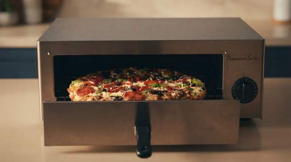 Editorial illustration for Pizza Oven or Sous Vide? The $200 Gourmet Gadget Decision, Settled by Cooking Style